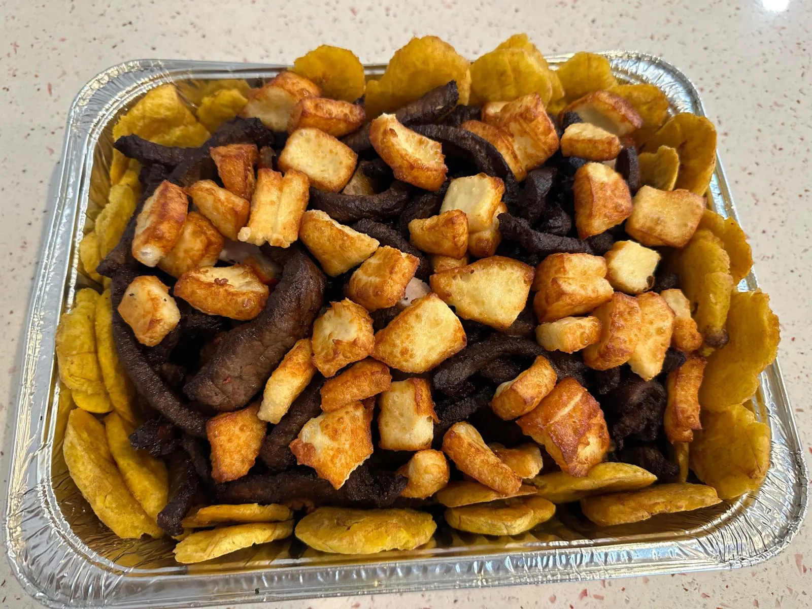 Picadera tray with fried cheese, salami and tostones