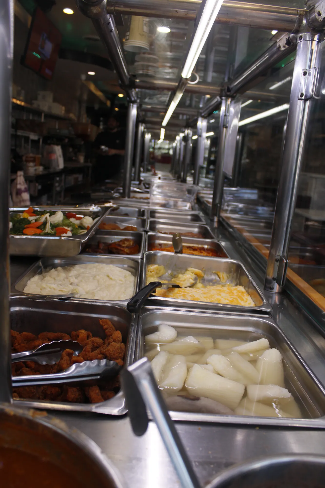 Yuca, rice and meats on the steam table