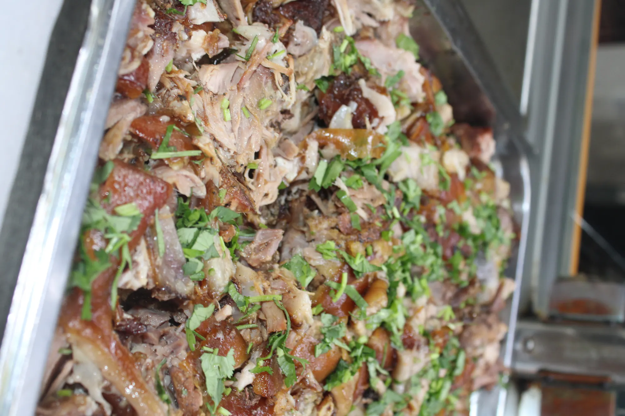 Pernil tray at the steam table