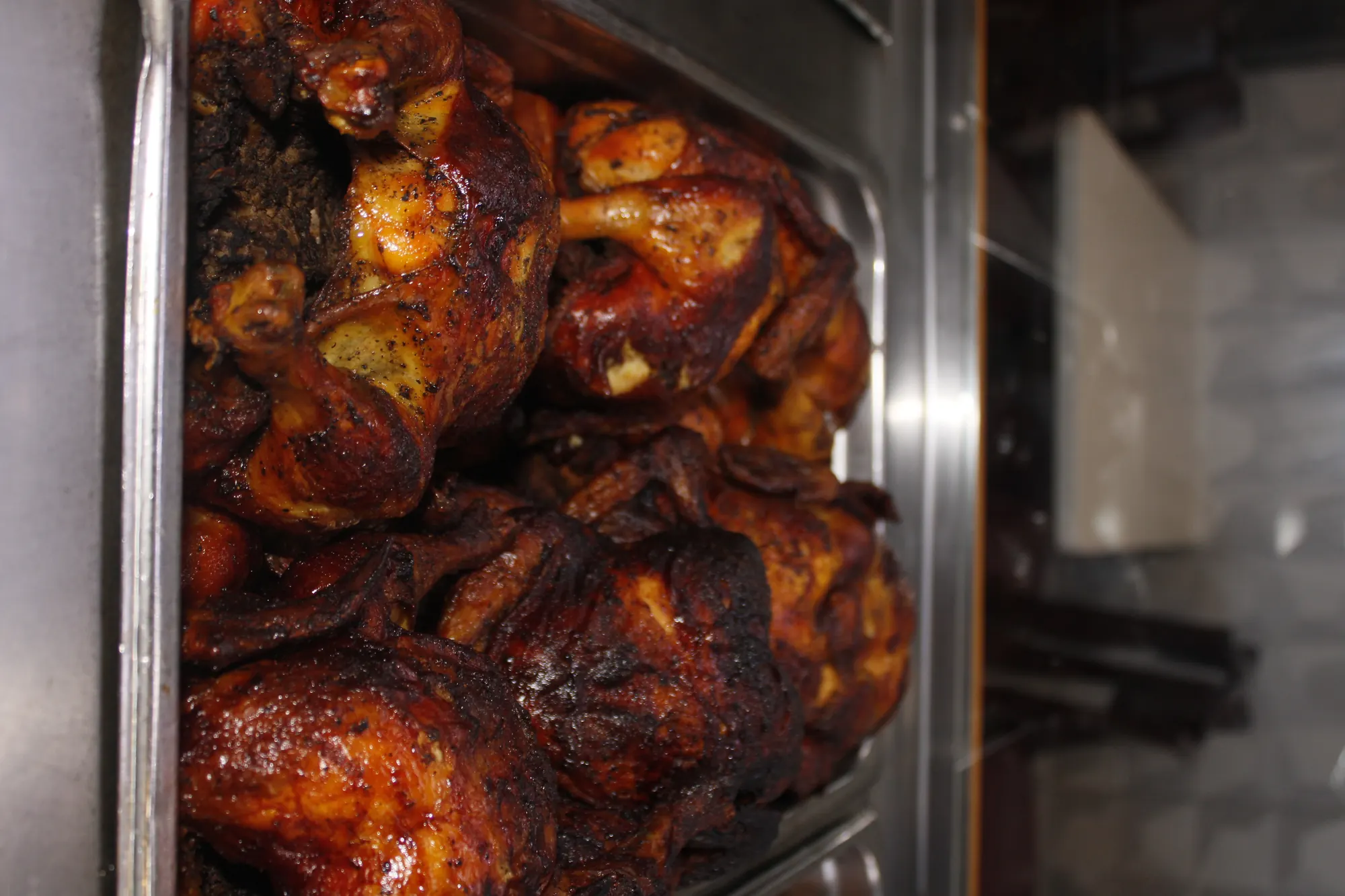 Rotisserie chickens stacked in the hot case