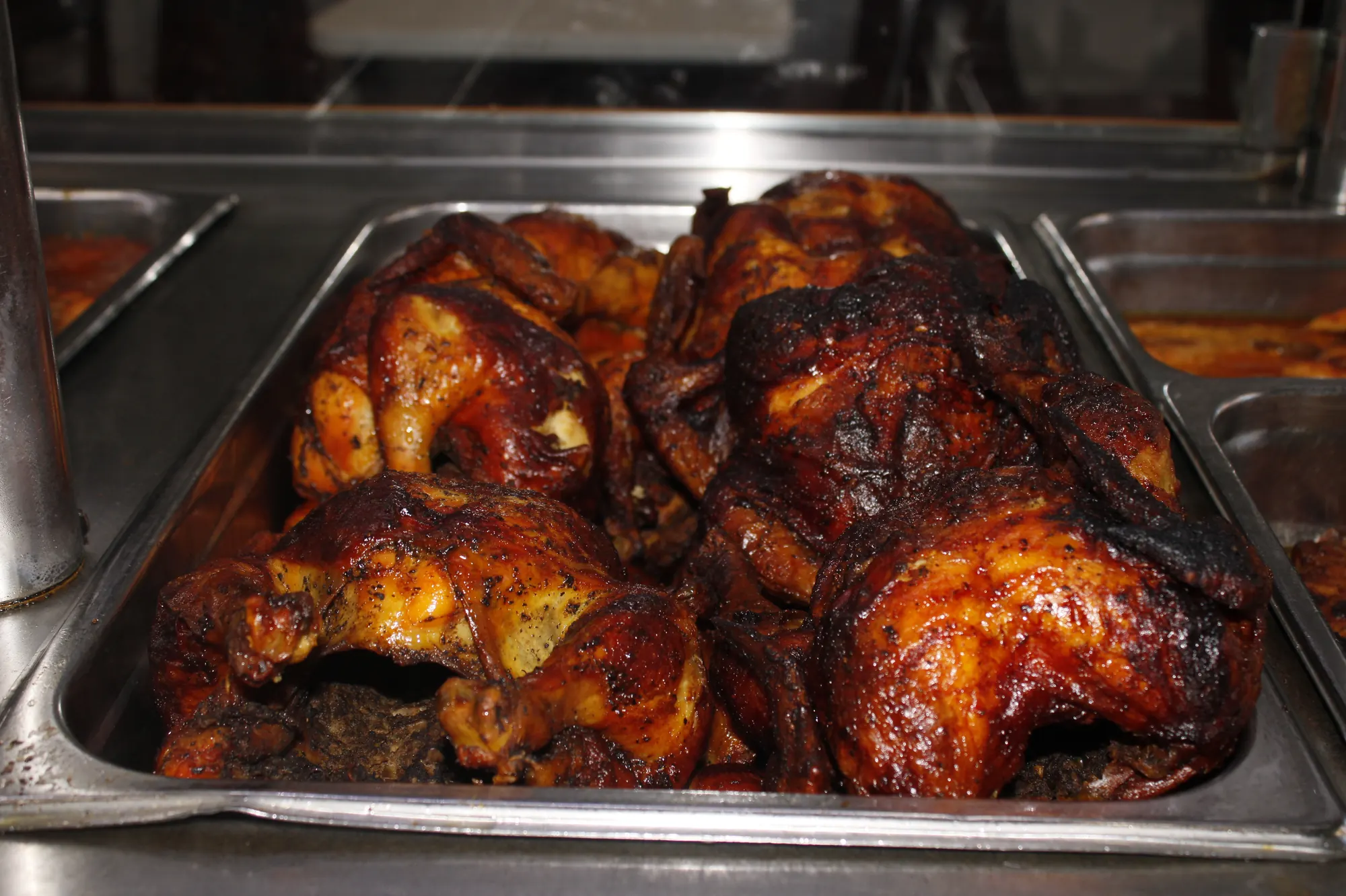 Tray of golden rotisserie chickens